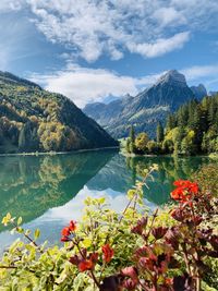 Scenic view of lake and mountains against sky