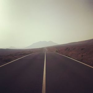 Empty road against sky