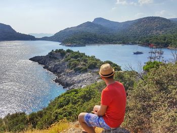 Rear view of man looking at sea