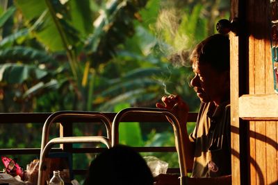 Rear view of woman sitting outdoors