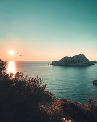 Scenic view of sea against clear sky during sunset