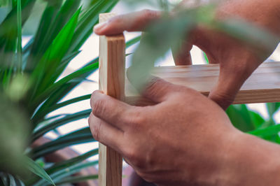 Close-up of hand holding painting