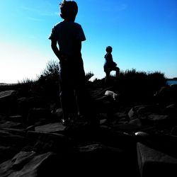 Full length of woman standing against clear blue sky