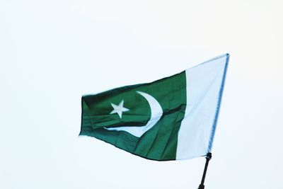 Low angle view of flag against clear sky