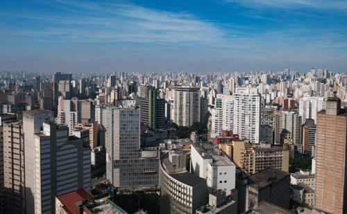 High angle view of modern buildings in city against sky