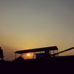 Low angle view of silhouette building against sky during sunset