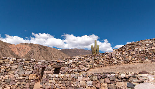 Scenic view of rocks against blue sky