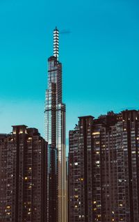 Low angle view of buildings against clear blue sky