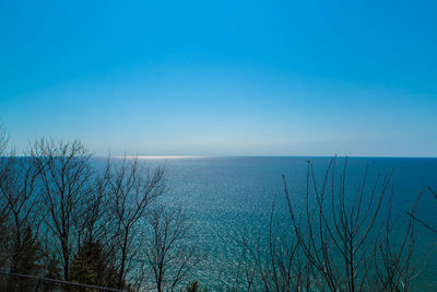 Scenic view of sea against clear blue sky