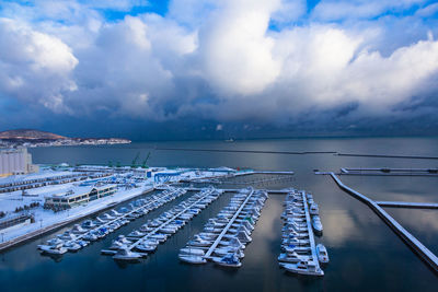 High angle view of boats moored in sea against sky