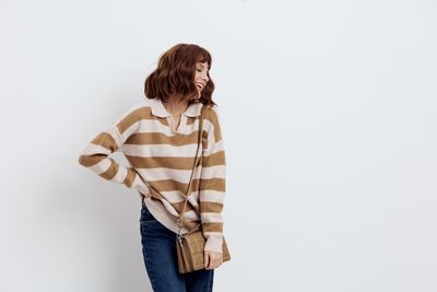 Rear view of woman standing against white background