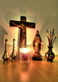 Close-up of illuminated lamp on table