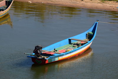 High angle view of man on boat moored in lake