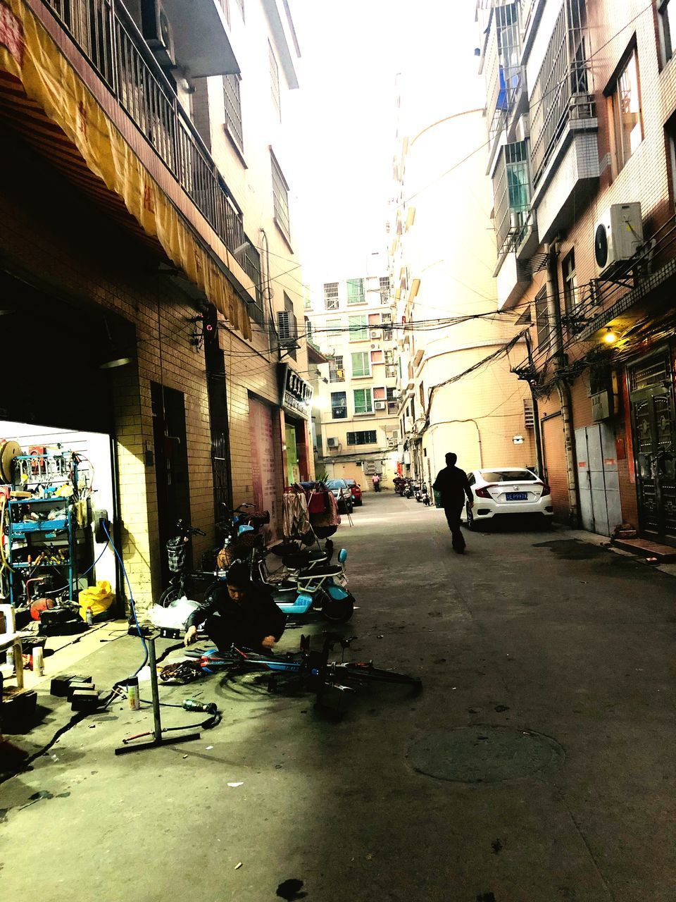PEOPLE ON STREET AMIDST BUILDINGS