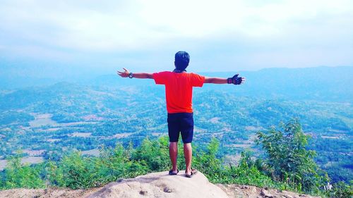 Man standing on mountain against sky