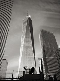 Low angle view of skyscraper against cloudy sky