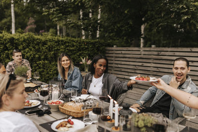 Friends having meal in garden