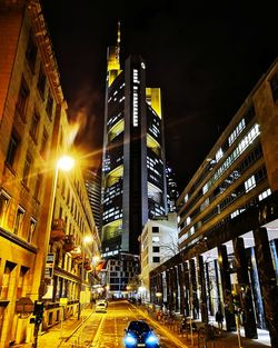 Illuminated city street and buildings at night