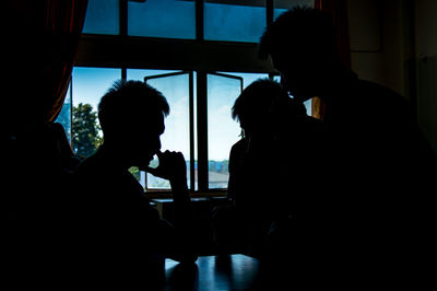 Silhouette people sitting in restaurant