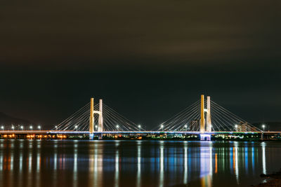 Illuminated suspension bridge at night