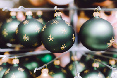 Close-up of christmas decorations hanging indoors