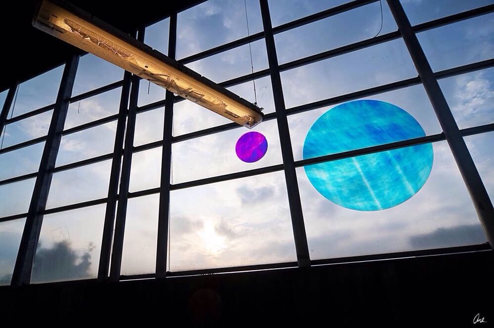 low angle view, sky, geometric shape, circle, multi colored, shape, blue, balloon, sphere, glass - material, cloud - sky, pattern, built structure, architecture, window, transparent, no people, day, outdoors, cloud