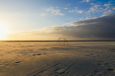 Scenic view of beach against sky during sunset