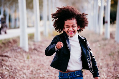 Portrait of smiling young woman standing outdoors