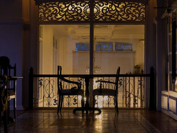 Empty chairs and table at entrance of building