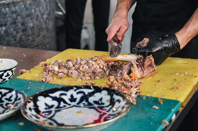 Midsection of man preparing food