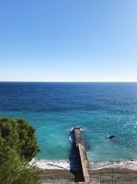 Scenic view of sea against clear blue sky