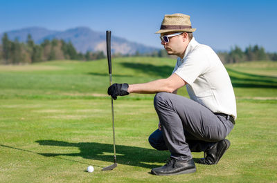 Midsection of man on golf course