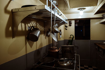 Close-up of kitchen utensils hanging from rack at home