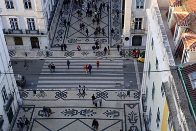 High angle view of people walking in street in city