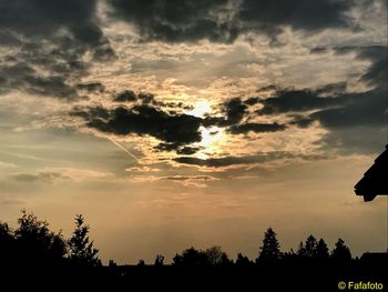 Low angle view of silhouette trees against sky during sunset