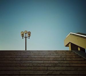 Low angle view of street light against blue sky