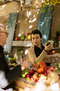 Portrait of woman holding food at home