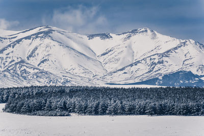 Scenic view of snowcapped mountains against sky