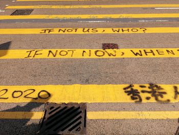 High angle view of yellow sign on road