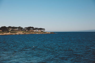 Scenic view of sea against clear blue sky