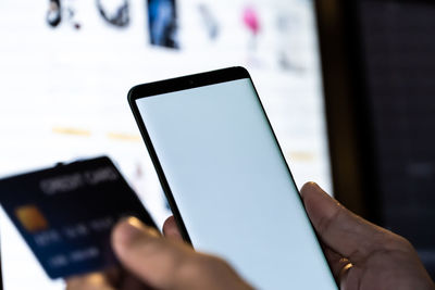 Close-up of hand using mobile phone