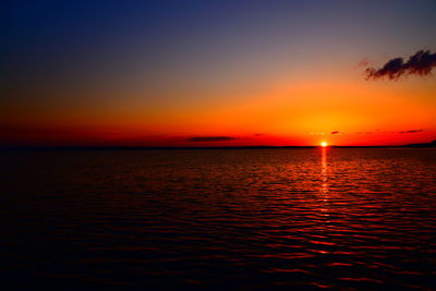 Scenic view of sea against romantic sky at sunset