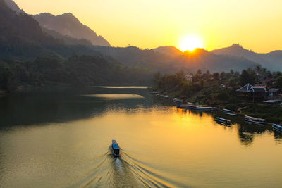 Scenic view of river against sky during sunset