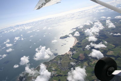 Aerial view of aircraft wing over sea during winter