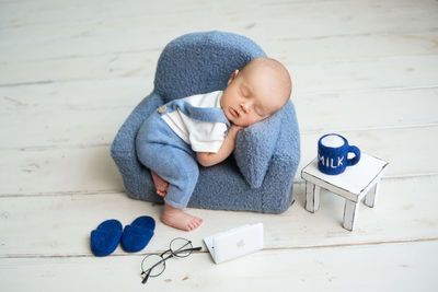 Portrait of cute baby boy sitting on table