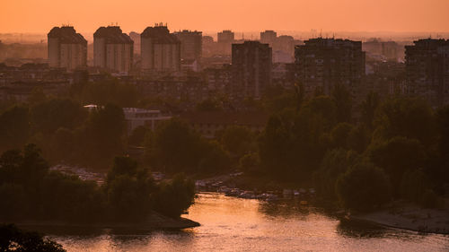 Buildings in city at sunset