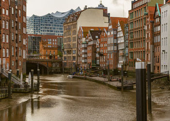 Bridge over canal amidst buildings in city