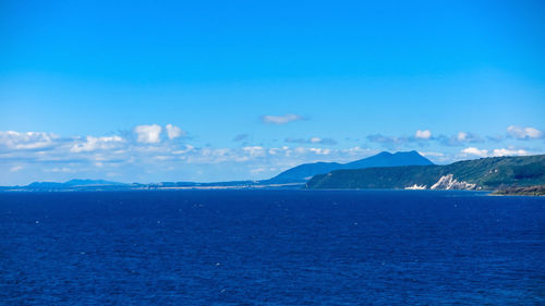 Scenic view of sea against blue sky