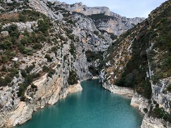 High angle view of river amidst mountains