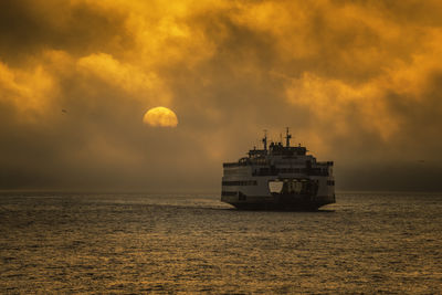 Ship on sea against sky during sunset